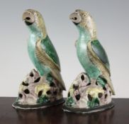 A pair of Chinese famille verte glazed biscuit models of parrots, 19th century, mounted on later