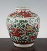 A Chinese wucai ovoid jar, Transitional period, painted with lion-dogs and flowers amid foliage,