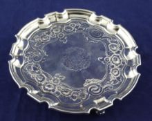 An early George II silver waiter, of shaped circular form, with engraved armorial and later?