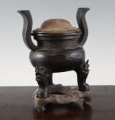 A Chinese bronze ding-shaped censer, 16th / 17th century, with high scrolled handles, leiwen band