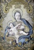 A 19th century polychrome silk embroidered panel, Madonna and child, within a 17th century carved