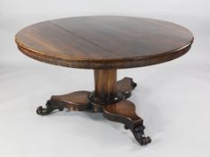 A Regency rosewood circular tilt top breakfast table, with cylindrical column, still leaf carved