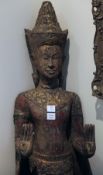 A Thai painted and parcel gilt wood standing figure of Buddha, mounted on a plinth, 66in.