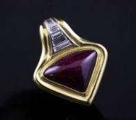 A stylish 18ct gold and platinum, ruby and baguette cut diamond pendant, by Andrew Clunn, of