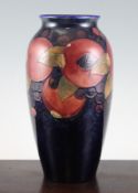 A William Moorcroft pomegranate pattern ovoid vase, with cobalt blue ground, impressed and inscribed