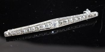 A 1920`s/1930`s white gold and graduated diamond bar brooch, of navette form, set with cushion cut