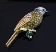 A cased 1990`s 18ct three colour gold, diamond, emerald and yellow sapphire set bird brooch,