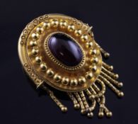 A Victorian gold and cabochon almandine garnet set locket pendant/brooch, of oval form, with
