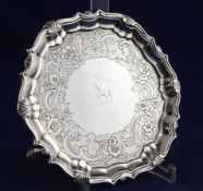 A George II silver waiter, of shaped circular form, with later? decoration and engraved armorial,