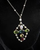 An Edwardian gold and silver, multi gem pendant, of cruciform shape, set with opal, peridot,