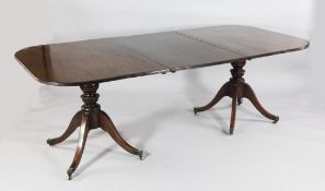 A Regency style mahogany twin pillar dining table, with reeded D ends and an extra leaf, extends