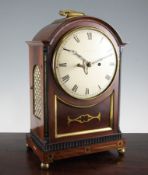 A Regency brass inset mahogany bracket clock, with arched ebony inset case and circular painted