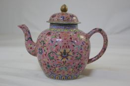 A Chinese pink ground famille rose wine pot and cover, Daoguang mark but later, enamelled with lotus