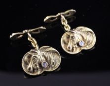 A pair of gold and diamond chip set cufflinks, each decorated with a bust of a horse, 0.75in.