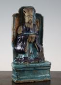 A Chinese Fahua-decorated seated figure of an emperor, Ming dynasty, on a moulded plinth, label