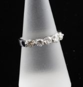 An 18ct white gold and five stone diamond half hoop ring, size O.