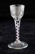 A colour twist stem wine glass, c.1765, the ogee bowl over an opaque twist corkscrew gauze with