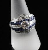 An Art Deco style platinum, sapphire and diamond set dress ring, with pierced setting, the central