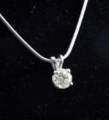A 14ct white gold and solitaire diamond pendant, the round brilliant cut stone weighing