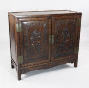 A 19th century Chinese rosewood cabinet, with two doors carved with fruiting gourd branches within a