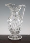 A heavy cut glass jug, c.1830-40, with step cut neck above lozenge cut body, on a star cut foot,