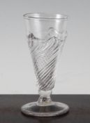 A flami-form dwarf ale glass, c.1750, with wrythen moulded conical bowl and knopped stem, on a