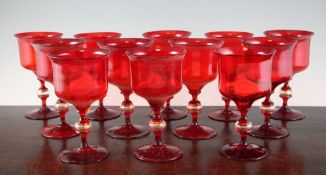 A set of twelve Venetian ruby glass goblets, 20th century, with clear and gilt decorated ball knop