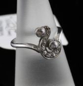 A 1920`s platinum and diamond set dress ring, of scrolling design, size K.