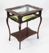 An Edwardian mahogany floral marquetry inlaid bijouterie table, with glass top and sides, shaped