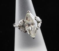 A white gold and solitaire marquise cut diamond ring, the central stone weighing approximately 4.