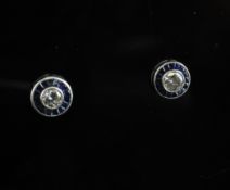 A pair of 14ct white gold, sapphire and diamond set target earrings, with central round cut