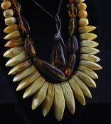 A single strand jagged and rough cut pale amber bead necklace, together with one other necklace