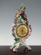 A Meissen cartouche shaped mantel timepiece, 19th century, profusely encrusted with flowers and