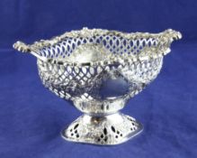 A late Victorian pierced silver pedestal bowl, of lozenge form, with repousse floral swag decoration