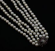 A triple strand cultured pearl necklace with two clasps, 14ct white gold ruby and diamond cluster