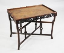 A 20th century Chinese rosewood rectangular tray top table, with floral carved and pierced frieze,