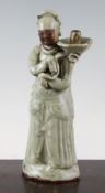 A Chinese Longquan celadon figural jostick holder, 15th / 16th century, the standing figure with