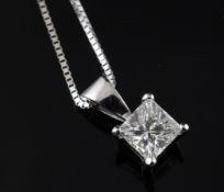An 18ct white gold and solitaire princess cut diamond pendant, on an 18ct white gold fine link