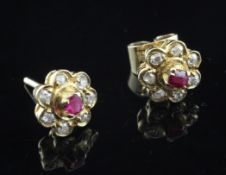 A pair of 9ct gold, ruby and diamond set ear studs, of flower head design.