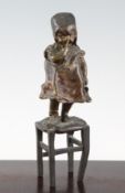 Juan Clara. A 20th century Spanish patinated bronze model of a young girl standing on a stool,
