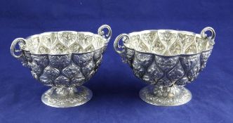 A Victorian silver two handled pedestal bowl by Charles Stuart Harris, of circular form, embossed