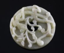 A Chinese archaistic grey-celadon jade `dragon` bi disc, 17th/18th century, carved in high relief