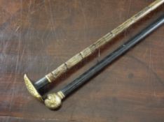 A late 19th century walking cane, with square Toledo ware damascened steel handle, together with a