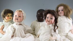 An Armand Marseille No.590 bisque head doll, another bisque head doll and three composition head