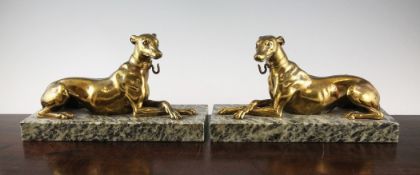 A pair of Victorian ormolu models of recumbent greyhounds, on green marble plinths, 12in.