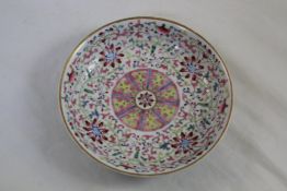 A Chinese famille rose `lotus` dish, Qianlong mark but later, the centre painted with a medallion