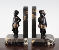 A pair of 1930`s cold painted bronze and marble bookends modelled as standing nubians, 6.75in.