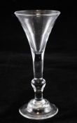 A George II `kit kat` wine glass, c.1750, with drawn trumpet bowl, the plain stem with inverted