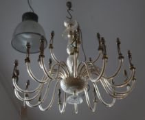 A 20th century glass multi-light chandelier, with facet decorated stem and twenty four scrolling