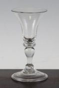 A George II baluster wine glass, c.1730-50, with waisted bell shaped bowl above an annular knopped
